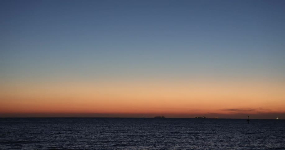 Oceanside homes are lit up at dusk