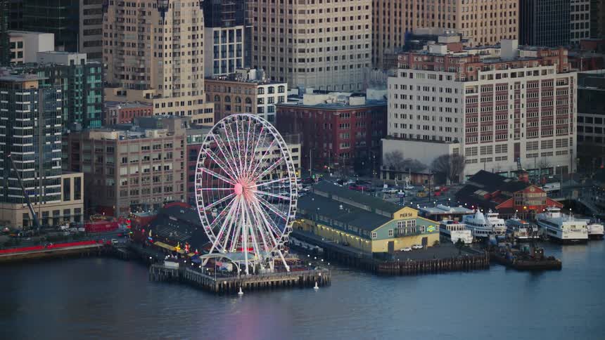 Beautiful tight shot Aerial of downtown Seattle and the Seattle Great Wheel with Elliot Bay and the Puget Sound in the foreground