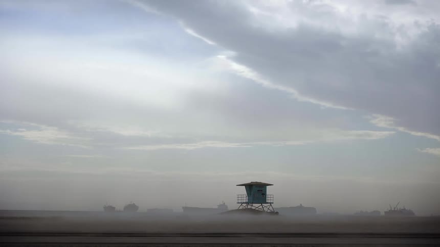 Intense wind moves sand on beach
