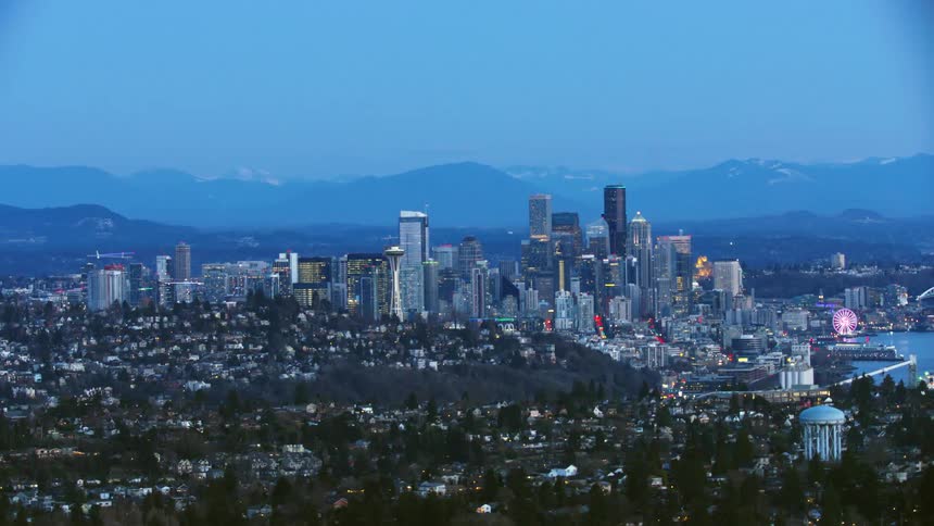 Downtown Seattle and Elliott Bay are seen in this beautiful aerial shot after sunset during the blue hour light
