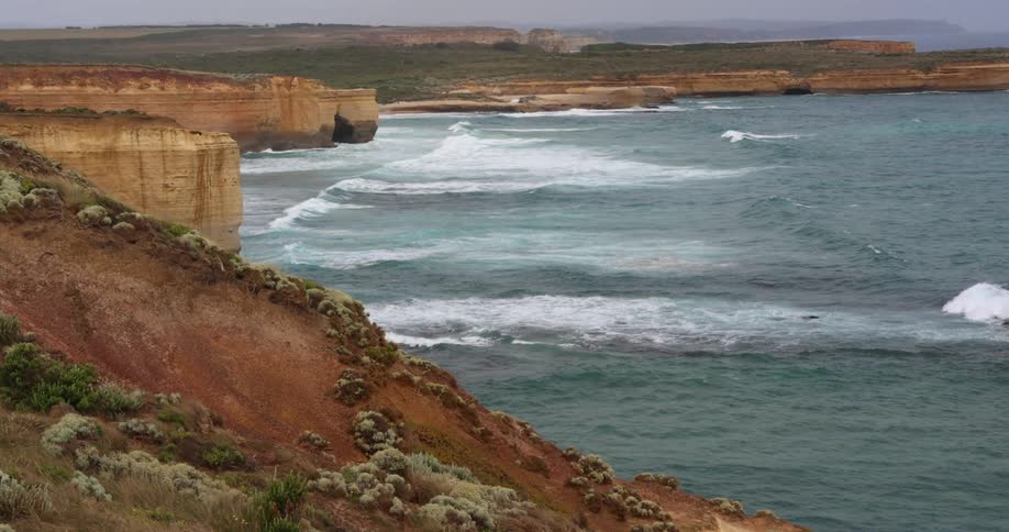 Waves rolling in to cliffs on the shore