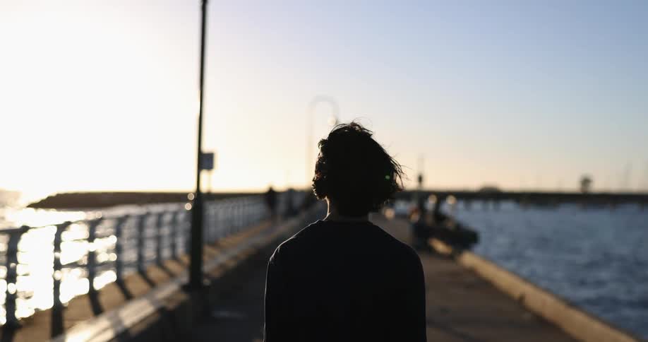 A person walking down a boardwalk