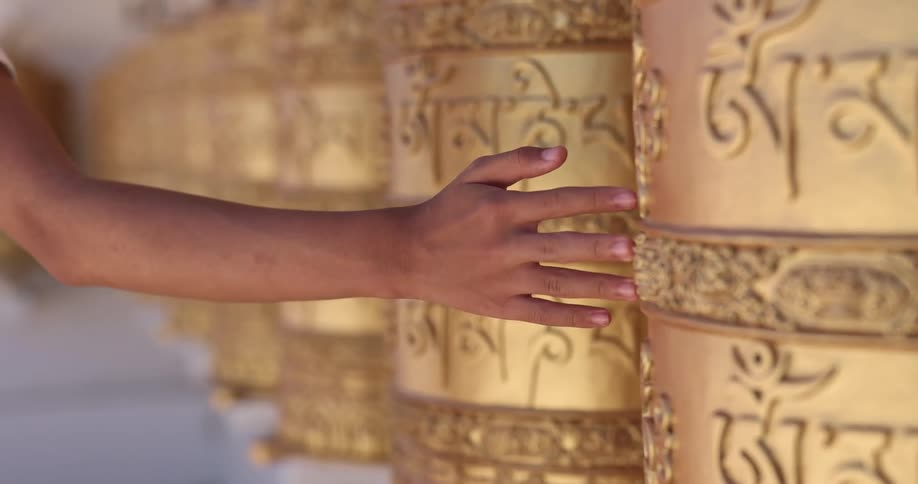 A person traces his hand over the row of pillars