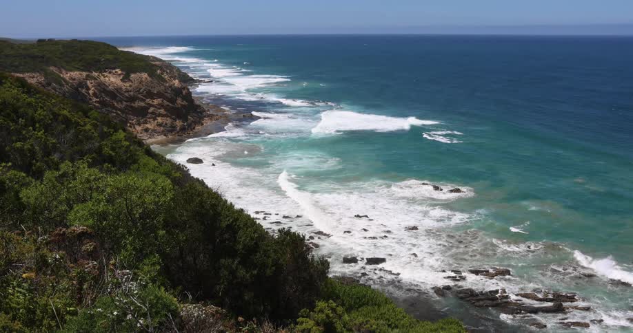 An aerial view of waves rolling in to the shore
