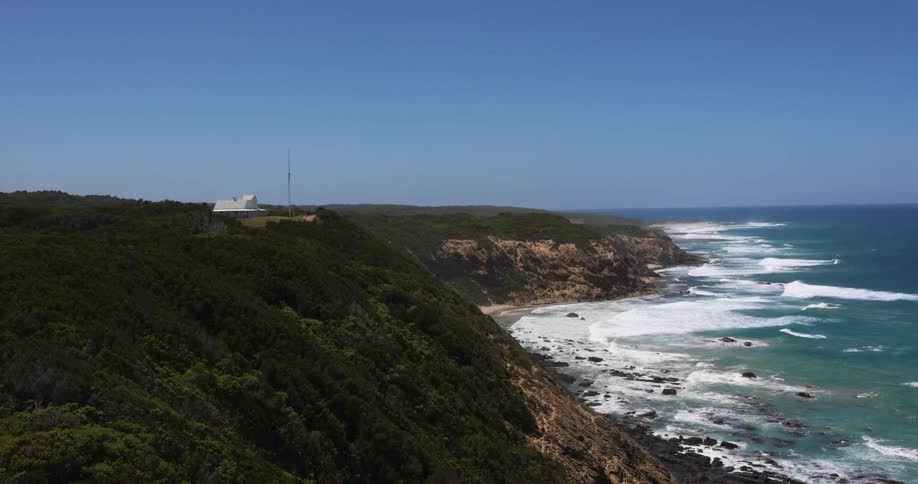 A rocky coast with cliffs and waves with the sky and clouds in the background