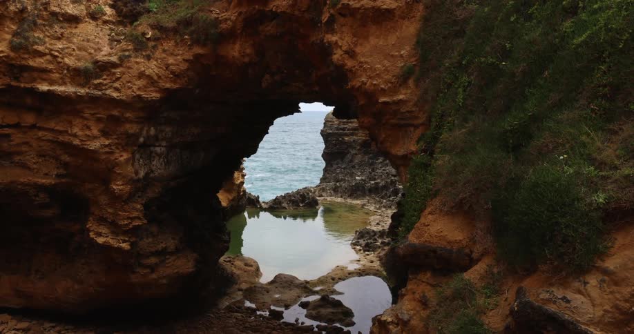 Natural sea arch made of stone on the coast of a beach near the ocean