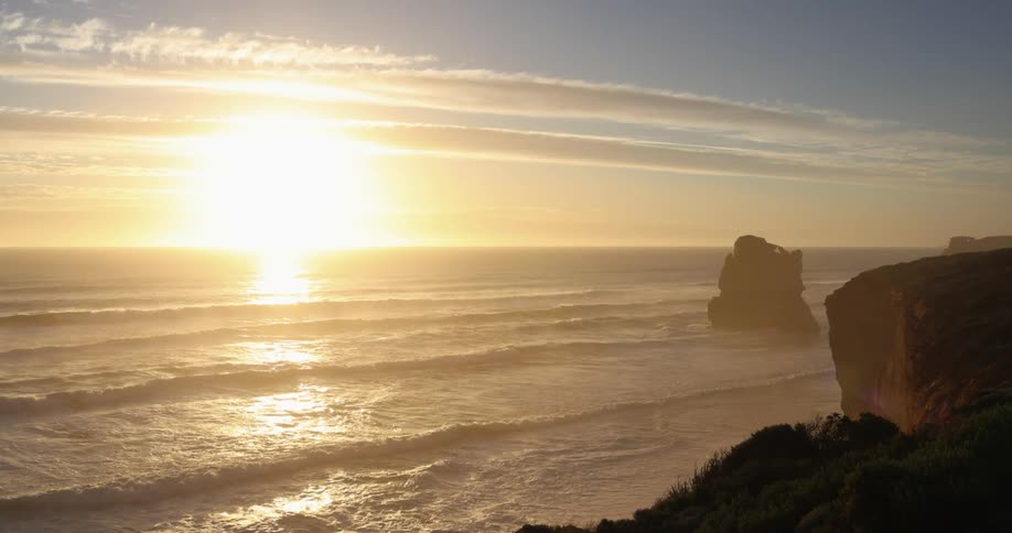 Waves roll in to the shore as the sun sets