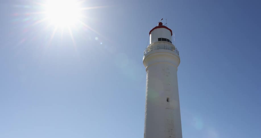 A view of a white lighthouse tower
