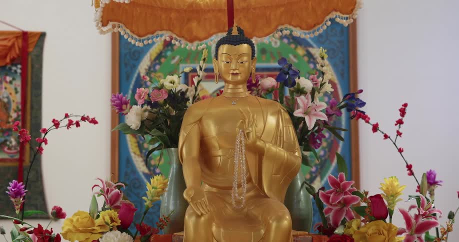 A statue of buddha is on the altar