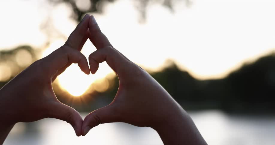 A person making a heart with their hands