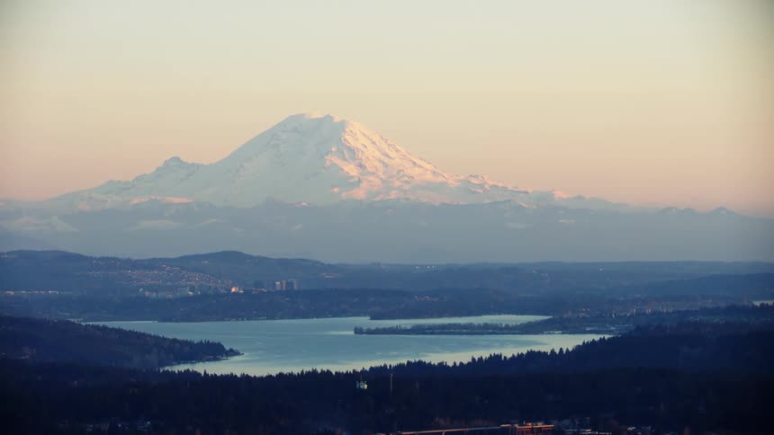 Aerial view of Mount Rainier and Lake Washington as the sunsets over the beautiful city of Seattle on a clear evening