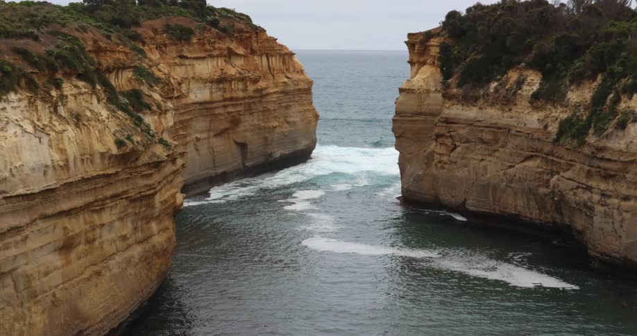 A rocky coast with cliffs with the ocean sky and clouds in the background
