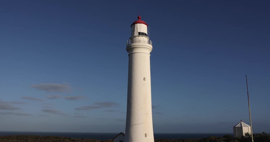 White of lighthouse contrasts with blue of sky and ocean