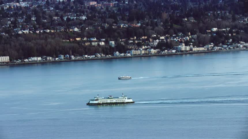 Washington State Ferries motor across the Puget Sound and Elliott Bay transporting passengers from Bainbridge Island and other locations in the San Juan Islands to downtown Seattle