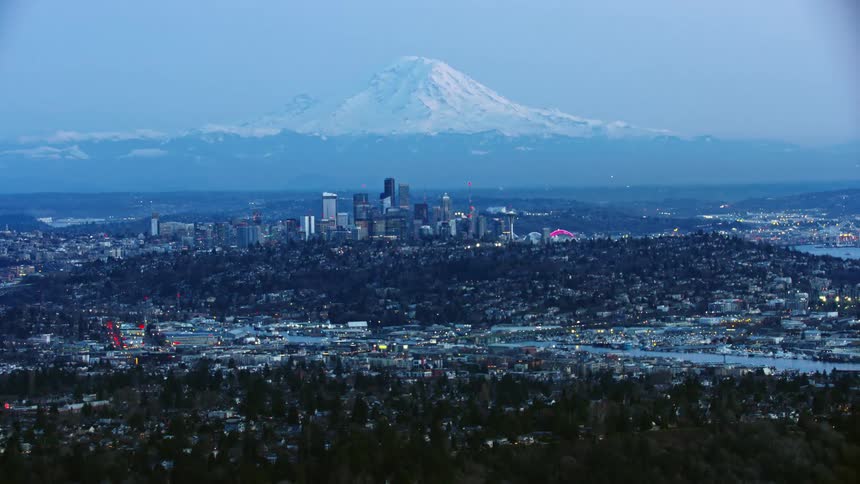Seattle and the downtown skyscrapers rise in front of Mount Rainier in this spectacular aerial of the cityscape