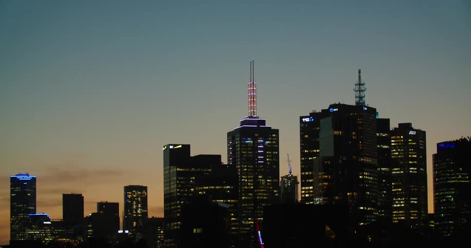 Colorful night lights on the city skyline at sunset