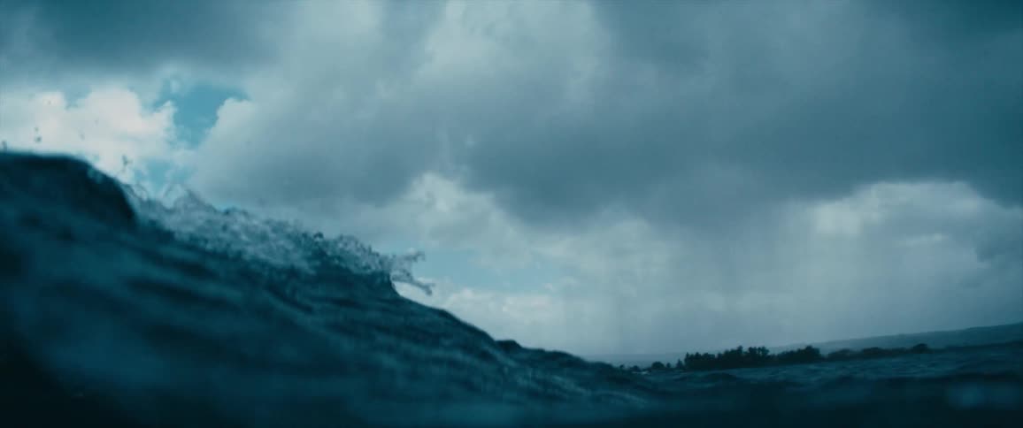 Ocean waves roll on a cloudy day