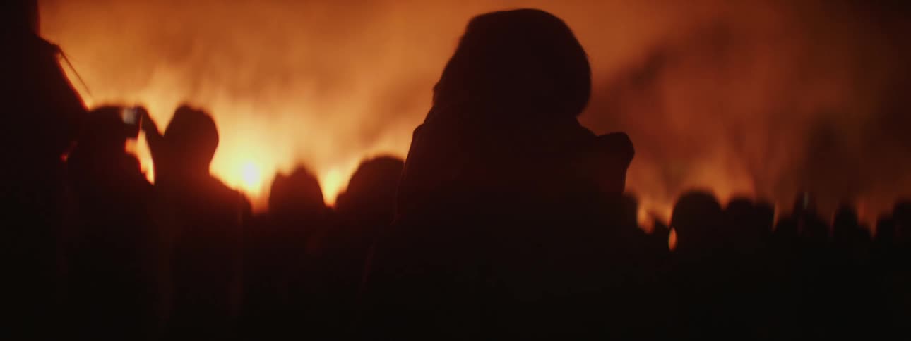 A group of people standing around a fire