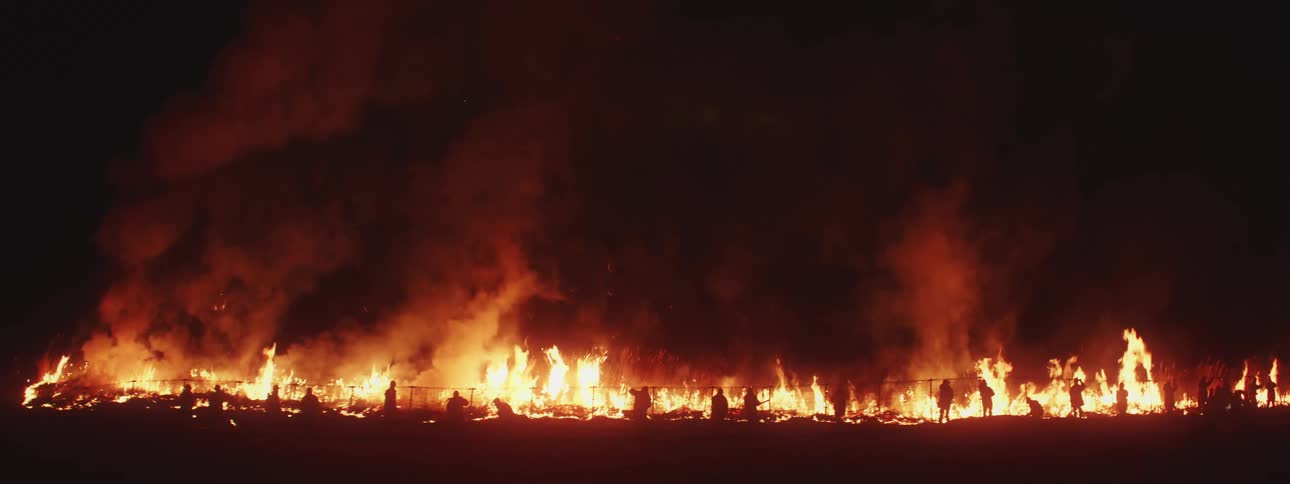 Firemen fighting a wildfire in the dark