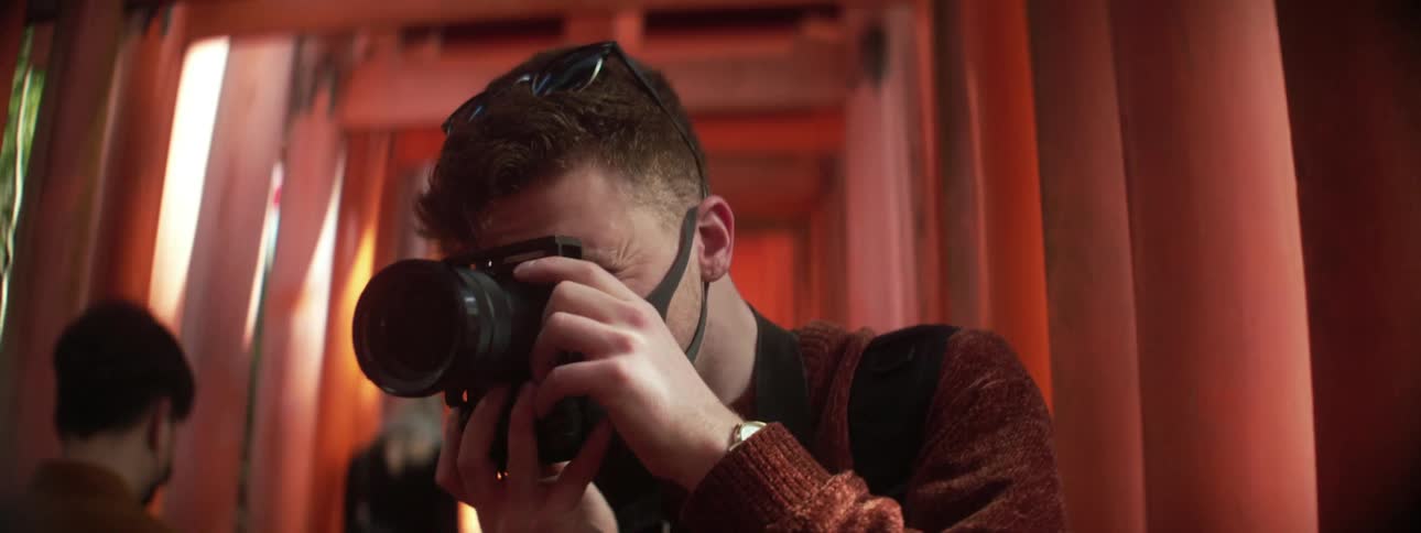 A man takes a photo with his camera