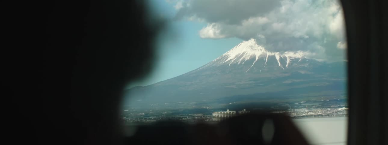The train travels past the town near the mountain