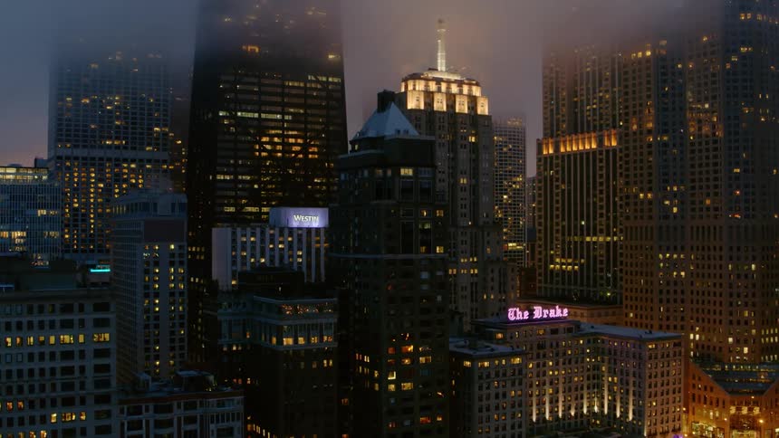 Illuminated foggy skyscrapers in Chicago at night
