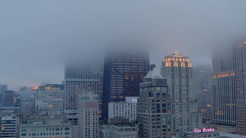 Fog covers the top of skyscrapers in downtown Chicago