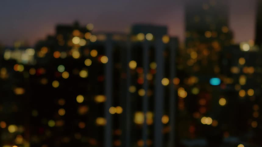 Window lights on skyscrapers flicker and glow in Chicago skyline at night