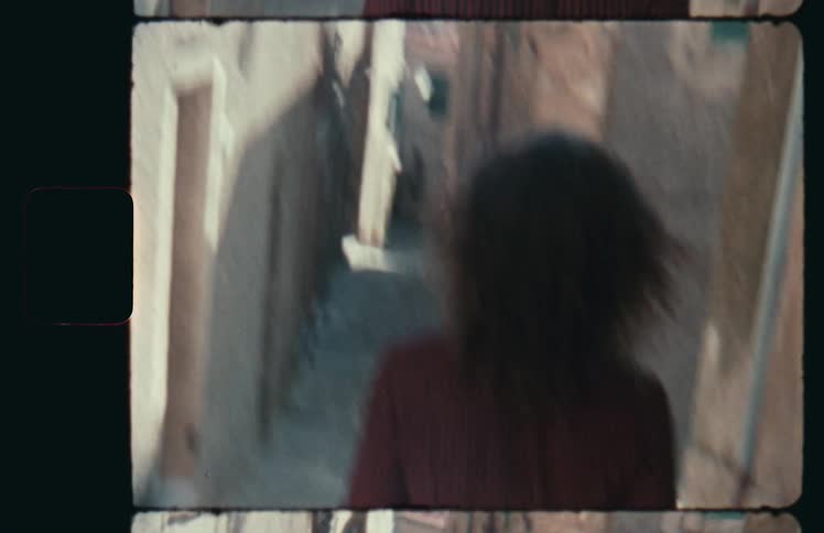 Woman walks quickly down the alley
