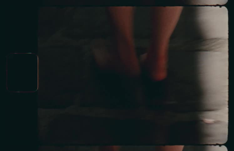 Woman walking barefoot on the street of a small town