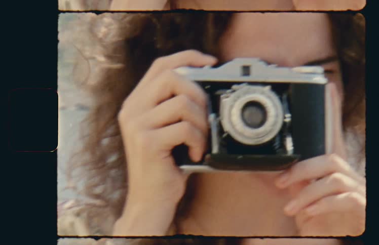 Woman aiming vintage camera