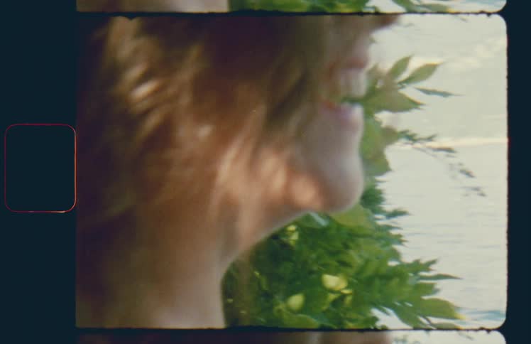 Close up of a woman smiling in front of a lake