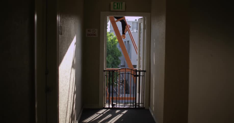 A person walks up the fire escape outside