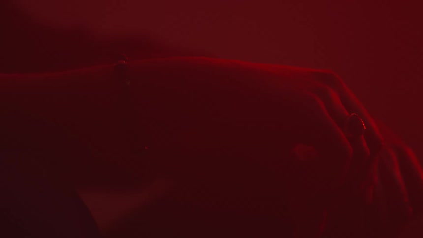 Person and their hands and background are all tinted crimson