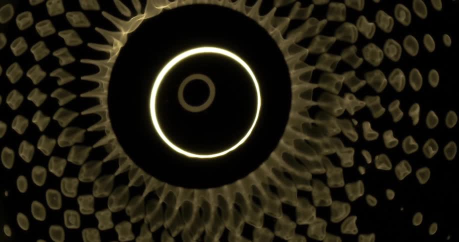 Concentric circles on a digital screen spin as sections from the outer circle break off into small pieces