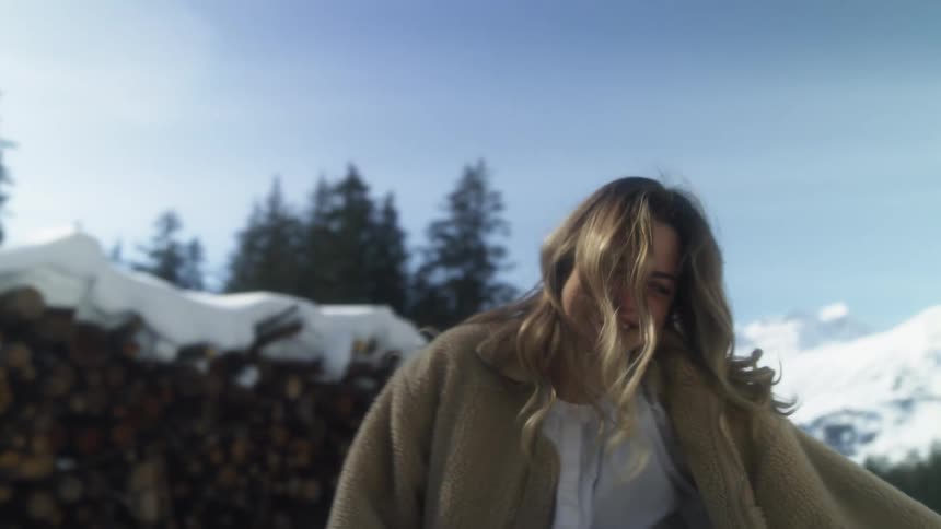 A woman is laughing and dancing outside