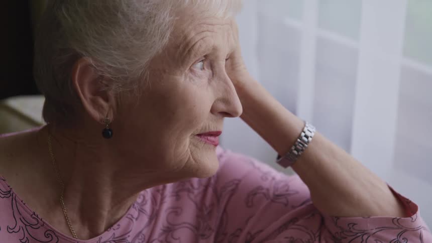 A woman sitting and staring out a window