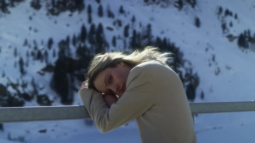 A portrait of a woman outdoors near a mountain