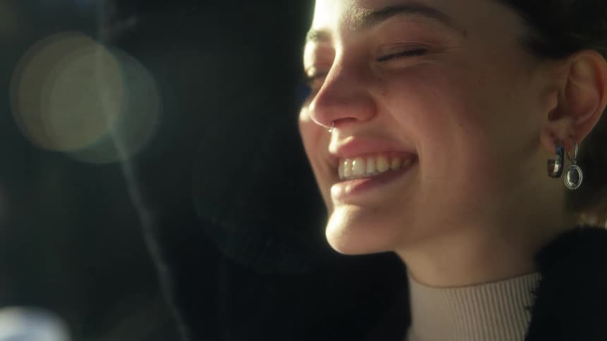 Young woman standing outdoors smiling