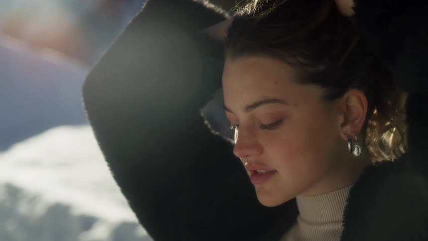 A close up portrait of a woman outdoors