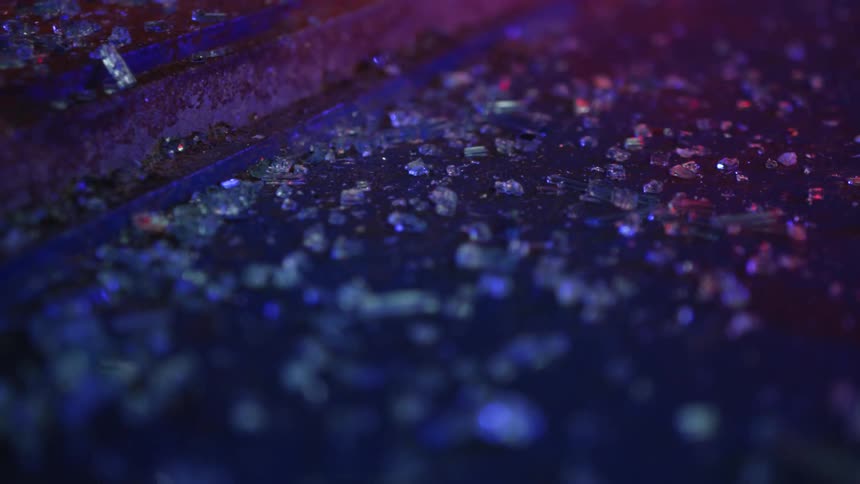 Broken glass on a paved ground