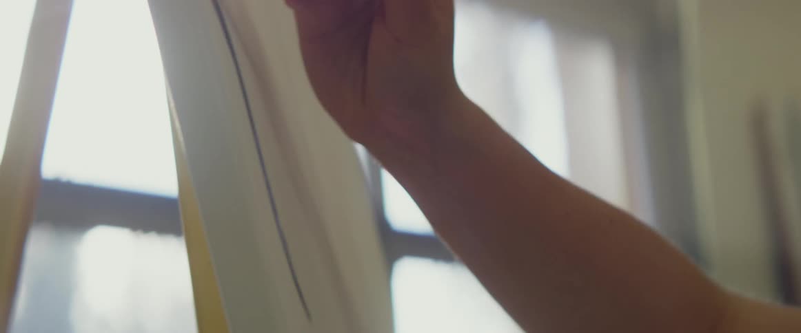 A woman is painting with a small brush