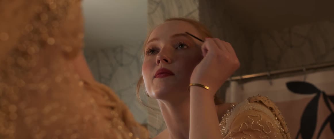 Woman applying makeup in front of a mirror in the bathroom