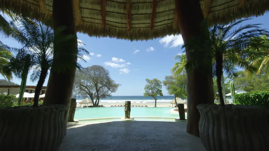 A view of a pool at a resort next to the ocean