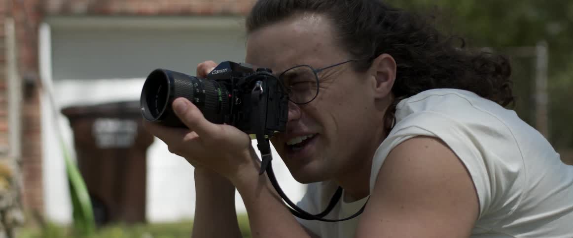 A male photographer taking pictures outdoors