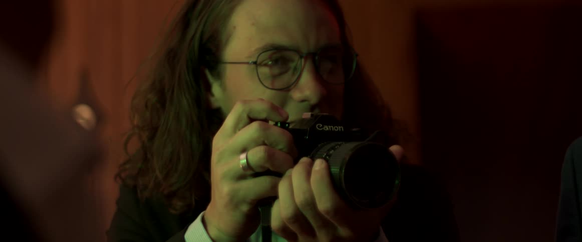 A male photographer taking a picture with a cannon camera
