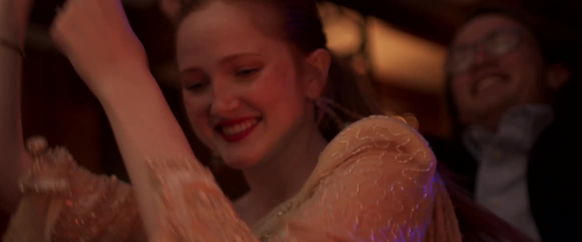 Woman wearing a wedding dress dancing in a party at night