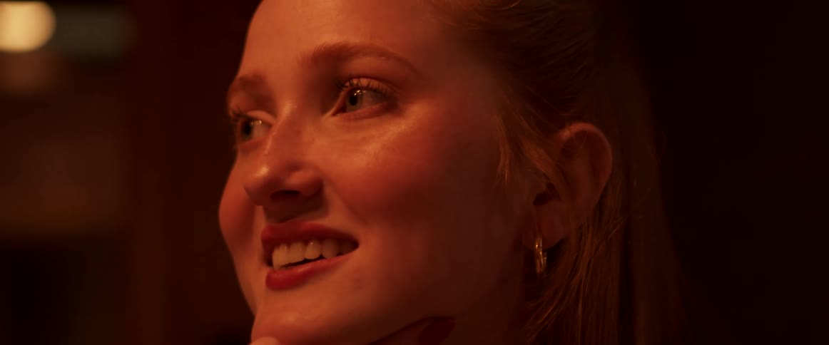 A young blonde woman smiling