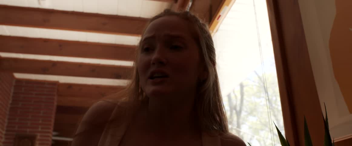 Young blonde woman sitting in a restaurant talking