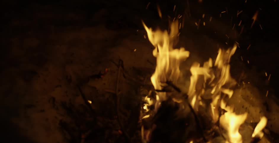 A fire burning outside at night
